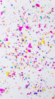 colorful confetti sprinkles on a white background