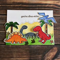 a card with dinosaurs and birds on it