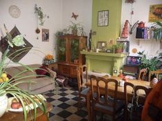 a living room filled with furniture and lots of plants