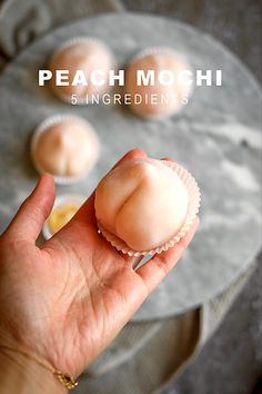 a hand holding a small pastry on top of a plate with the words peach mochi ingredients