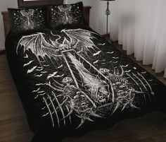 a bed covered in a black and white comforter