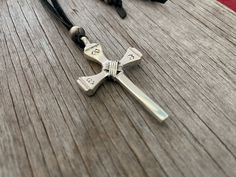 ~ Limited Quantity ~Gorgeous artisan sterling silver sand-cast style cross pendant!This awesome cross was made by an artist from antique Santa Fe railroad nails, hand stamped and wire wrapped then cast in sterling silver.Simple yet powerful, a true labor of love!A lariat is a necklace without a clasp that is worn wrapped around the neck or with a loose knot tied behind the neck. A lariat can be worn long or as a choker with the ends hanging longer in the front. You can also move the Navajo Style Adjustable Sterling Silver Cross Pendant Jewelry, Adjustable Sterling Silver Cross Pendant, Handmade Adjustable Crucifix Jewelry, Unique Adjustable Cross Jewelry, Adjustable Unique Cross Jewelry, Unique Sterling Silver Cross Necklace, Cross-shaped Soldered Jewelry Gift, Adjustable Nickel-free Cross Pendant Jewelry, Adjustable Engraved Cross Pendant Jewelry