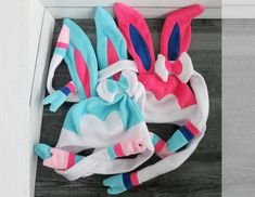 several colorful bunny ears on top of a wooden floor next to a white door frame