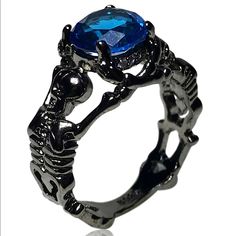 Available Ring Sizes: 6, 8 Material: Crystal And Zinc Bundle And Save. All Jewelry Is Buy One Get One Half Off. Message Me To Create Your Bundle. Shameless Sales Pitch: Do You Like Skeletons? Well He're 2 Black Colored Skeletons Holding Up A Beautiful Blue Gem. What Could Be A More Beautiful Combination. Black And Blue Ring, Gothic Black Skull Ring For Halloween, Adjustable Black Punk Skull Ring, Black Skull Print Ring, Gothic Black Rings With Skull Print, Black Skull Rings In Punk Style, Black Skull Rings Punk Style, Elegant Black Skull Ring For Halloween, Punk Style Black Skull Rings