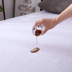 someone is drizzling syrup on a bed