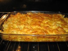 a casserole dish in an oven with the door open to show it's cooked food