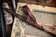 an old book with a knife on top of it