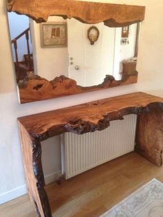 a wooden table sitting in front of a mirror