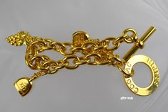 "This gorgeous Estate bracelet features brand-name cognac bottles by grapes vine / grapes clusters. The clasp is marked \"Cognac Frapini\". This estate jewelry is crafted of shining high polish 18K gold plated. Metal weight: 2.2 oz. Bracelet dimensions: 1 1/4\" wide x 8\" long with the toggle clasp. It is vintage item in very good condition. Please see enlarged pictures for a detailed view. All returns must be postmarked within 7 days from the date you received the item. All sales are final afte Gold Bracelets With Logo Charm For Formal Occasions, Formal Gold Bracelets With Logo Charm, Luxury Charm Bracelet For Anniversary, Vintage Gold Jewelry Aaa Quality, Luxury Gold Charm Bracelet For Anniversary, Charms Bracelet, Gold Charm Bracelet, Gold Plated Bracelets, May 7