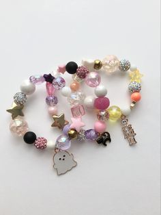 a bunch of bracelets that are on a white surface with some charms attached to them