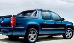 a blue truck is parked on the beach