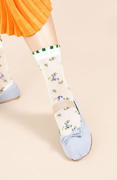 Delicate flowers and laced cuffs embellish these sheer crew socks that add a sweet detail to any ensemble. Nylon Hand wash, dry flat Made in Japan Cute Lace Trim Socks For Spring, Summer Lace Trim Fitted Socks, Fitted Lace Trim Socks For Summer, Cute Green Socks For Spring, Summer White Socks With Lace Trim, White Lace Trim Socks For Summer, White Socks For Spring, White Mid-calf Summer Socks, Trendy White Socks For Spring