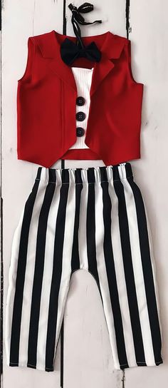 a red shirt and black and white striped pants with a bow tie on the front