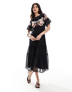 Dresses by Hope & Ivy Occasions made easy High neck Floral embroidery Flutter sleeves Fitted waist Tiered skirt Cut-out back Back zip closure Regular fit Chic Embroidered Evening Maxi Dress, Embroidered Maxi Dress For Summer Evening, Chic Floral Embroidered Maxi Dress, Chic Floral Embroidered Midi Maxi Dress, Black Embroidered Maxi Dress For Spring, Black Short Sleeve Embroidered Maxi Dress, Black Embroidered Short Sleeve Maxi Dress, Black Maxi Dress With Floral Embroidery, Embroidered Black Maxi Dress With Short Sleeves