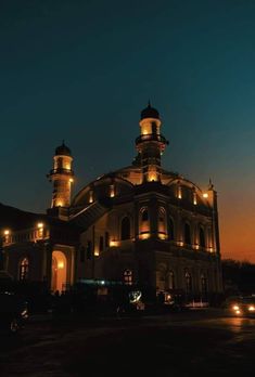 a large building with two towers lit up at night