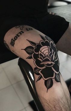 a man with a flower tattoo on his arm