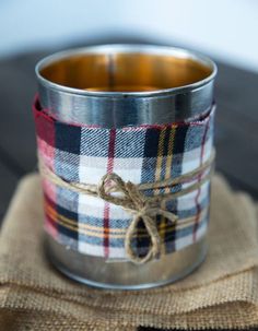 a metal cup with a rope tied around it sitting on top of a burlock