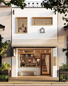 a coffee shop with two people sitting in the window