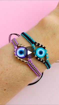 two bracelets with evil eyes and beads on the wrist, one has a blue eye