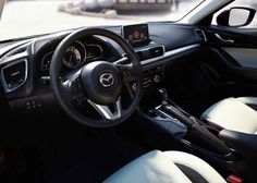 the interior of a car with steering wheel and dashboard