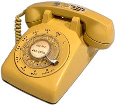 an old fashioned yellow telephone on a white background