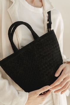 NEW! The Onyx Suede Tote is this season's must-have bag to take you through winter. Crafted from luxurious black suede, the hand woven design exudes sophistication and timeless elegance. The top zip closure and crossbody strap provide convenience and the interior pockets offer extra security and organization. Color: Onyx (Black) Handwoven suede leather Includes crossbody strap. Interior pockets Top zip closure Gold hardware Dimensions Length: 12 in / 30 cm Height with handle: 13 in / 33 cm Heigh Black Suede Bag With Detachable Strap, Chic Suede Bag With Zipper Closure, Luxury Suede Bag With Zipper Closure, Black Suede Luxury Shoulder Bag, Luxury Black Suede Shoulder Bag, Luxury Black Suede Bags, Elegant Suede Shoulder Bag With Zipper, Elegant Suede Shoulder Bag With Zipper Closure, Black Suede Crossbody Bag