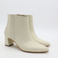 Take your sensible office booties to the next level and elevate your look with our stunning Aurlene ankle boots! For the ladies that have been needing a style to pair with work slacks or a jumpsuit, these are the ones for you. ETHICALLY HANDMADE IN COLOMBIA BY STIVALIMATERIALSManhattan, croc embossed leather in ivory/off whiteRubber outsole FEATURES Semi-pointed toe Below ankle height Leather wrapped block heel Side ankle zipper Alternating leather panel design MEASUREMENTS Heel Height: 2.6" Cal Leather Womens Shoes, Work Slacks, Leather Panel, Sustainable Leather, Leather Shoes Woman, Leather Care, Leather Wraps, Panel Design, Ankle Booties