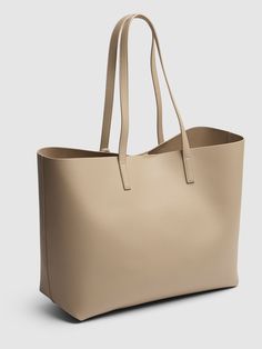 Height: 37cm Width: 28cm Depth: 13cm. Double leather top handles. Internal magnetic button closure. Detachable leather logo tag detail. Includes detachable leather zip pouch. Unlined Leather Zip Pouch, Beige Purses, Versace Brand, Ski Accessories, Logo Tag, Saint Laurent Bag, Dark Beige, Sports Accessories, Shopping Tote Bag