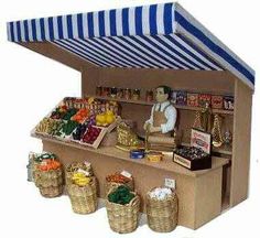 a toy store with baskets and food on display in front of an awning over the counter