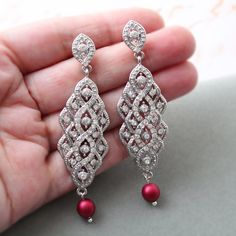 Vintage style  earrings  with pearls Colour: rhodium(silver tone) /clear/dark red/burgundy. Measurements: approx 7.8 cm . Width approx 2 cm. Materials:  rhodium components, clear crystal rhinestones, dark red/burgundy shade faux pearls 6-7 mm. Stud earrings. Great for wedding or other celebration. MORE SAME STYLE: https://www.etsy.com/uk/shop/BridalArtDeco?ref=listing-shop-header-item-count&section_id=23918122 Please note some images have been enlarged to allow for details to be shown. Read the descriptions for details on actual size of each item.In all my shop listing I have made every effort to ensure that the images match the item as closely as possible! However, colours do vary on different monitors.  Thank you for visiting / shopping ! Red Pearl Drop Earrings For Wedding, Red Pearl Earrings For Wedding, Elegant Red Bridal Earrings With Pearl Drop, Statement Pearl Earrings, 1920s Earrings, Bridal Earrings Statement, Crystal Cluster Earrings, Pearl Statement Earrings, Art Deco Hair