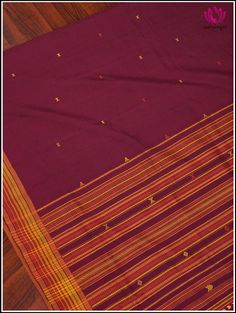 This Bhujodi/Kala cotton handloom saree is perfect for the summer season. The rich maroon hue creates an elegant backdrop for the traditional design. The pallu with simple geometric patterns are the highlights of Bhujodi Sarees. The wrap fringe of handmade tassels at the edge complements the weave. This saree comes with a fine red cotton blouse fabric with border. Fall and Pico - Done. Blouse - Unstitched. Please note: Color may vary slightly from the picture. Thread knots, Thread pulls and mino Thread Knots, Elegant Backdrop, Simple Geometric Pattern, Cotton Blouse, Blouse Fabric, Handloom Saree, Cotton Blouses, Geometric Patterns, Summer Season