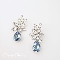 "Elegant Vintage style Bridal Earrings. Made with high-quality Crystal rhinestones in light blue and clear crystals. Gorgeous and elegant floral-inspired drops. Pair them with a cocktail dress or an over-sized sweater for an everyday look. Rhodium silver plated 2\" length, 1\" width Glass crystals Surgical steel posts, hypoallergenic" Elegant Light Blue Crystal Earrings For Gift, Elegant Blue Crystal Wedding Earrings, Blue Sparkling Crystal Earrings, Sparkling Blue Crystal Earrings, Large Blue Crystal Earrings, Blue Statement Earrings, Blue Chandelier, Bridal Statement Earrings, Crystal Cuff Bracelet