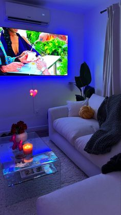 a living room filled with furniture and a flat screen tv mounted to the side of a wall