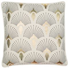 a white pillow with gold and silver designs on it's sides, in the shape of fan shapes