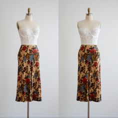 A lovely tan midi skirt, made from a very fine and lightweight wool blend. It has a large floral pattern in muted shades of red, brown, green, and blue, and has a nipped waist and flowy skirt. ☛   m e a s u r e m e n t s   ☚ Best for: S Waist: 28 Hips: 43 Length: 33 ☛   d e t a i l s   ☚ Era: 1990s Material: 90% rayon, 10% wool Condition: excellent ☛   v i s i t   t h e   s h o p   ☚ https://etsy.me/2Nd23kg ☛   instagram ┇ poppycockvintage ☛   facebook ┇ poppycockvintage Tan Midi Skirt, Cottagecore Skirt, Wool Midi Skirt, Flowy Skirt, Shades Of Red, 90s Vintage, Favorite Outfit, Wool Blend, Floral Pattern