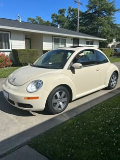 a white car parked in front of a house