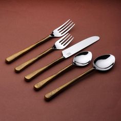 five forks, spoons and two knives on a brown surface