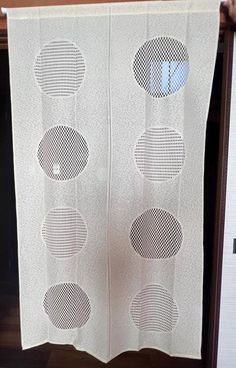 a white curtain with four circles on it