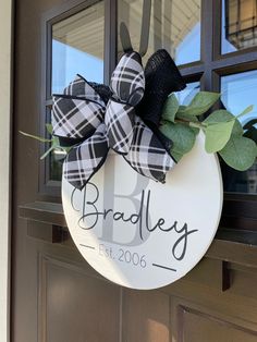 a door hanger with a black and white plaid bow