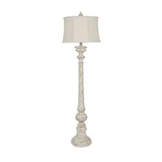 a white floor lamp with a shade on it's base and a light in the middle