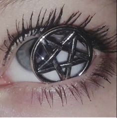 an eye with long lashes and a pentagramil on it