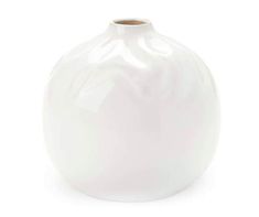 a white vase sitting on top of a table