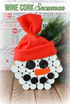 a wine cork snowman with a red hat on