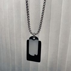 The classic dog tag necklace gets a modern pop of color thanks to a satin black tab. Strung on a thick silver rope chain, it makes an eye-catching addition to the simplest of looks. It's sure to garner lots of attention. Modern Black Necklaces For Everyday Use, Black Dog Tag Necklace For Everyday, Modern Black Necklace For Everyday Use, Modern Black Necklace For Everyday, Everyday Black Dog Tag Jewelry, Everyday Black Dog Tag Necklace, Modern Everyday Dog Tag Jewelry, Minimalist Dog Tag Necklace With Box Chain, Modern Dog Tag Box Chain Jewelry