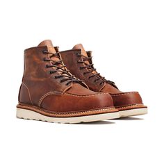 First introduced in 1952, Red Wing's Classic Moc is a style icon. It's still made using the same process as it was 70 years ago, and in this case, with a 6-inch upper made from copper-colored Rough & Tough Nubuck leather. The moc toe construction and Traction Tred rubber outsole for the base of the dependable boot, with Puritan triple stitching for durability and a storm welt for added water resistance. Finished with dark gun metal eyelets, they're made in the USA and come in "D" regular width. Red Wing Boots Blue, Red Wing, Red Wings, Nubuck Leather, James Bond, Style Icon, Copper, Boots, Red