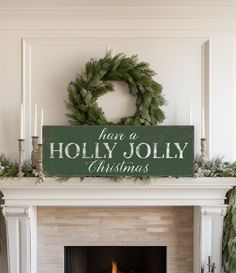 a fireplace with a christmas sign above it