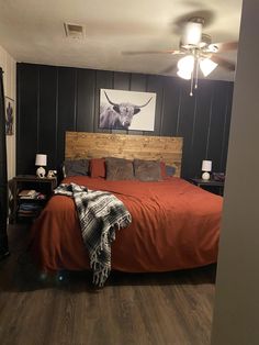 a bedroom with wood paneling and black walls