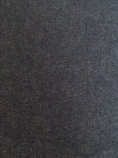 an image of a black cloth textured with white stitching on the back and sides