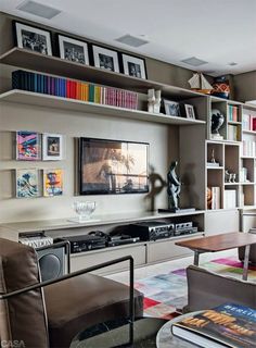 a living room filled with lots of furniture and bookshelves on top of each other