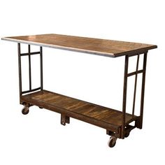 a wooden and metal table on wheels